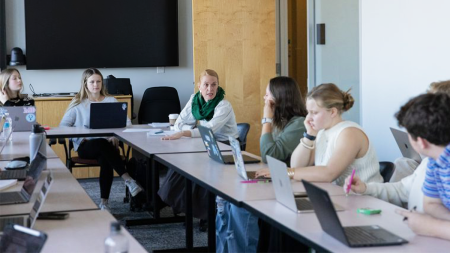 Professor Erinn Whitaker speaking to a group of U.N.C. students.